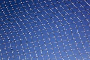 pattern created by string netting against a blue sky