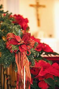 edmonton, alberta, canada; christmas garland with poinsettias on a wooden railing