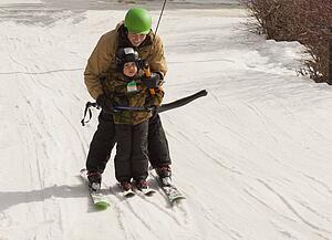 red deer, alberta, canada; a father teaching his young son how to ski
