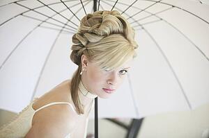 A Formal Portrait Of A Woman Under A White Umbrella