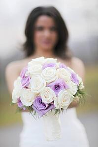 A Bride Holding Her Bouquet Of Roses