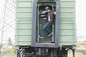 a teenage boy having fun on a train; portland, oregon, united states of america
