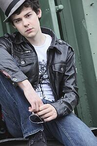 a teenage boy sitting on the back of a train; portland, oregon, united states of america