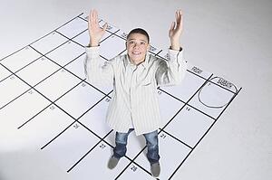teenage boy standing on a calendar