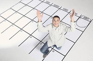 teenage boy standing on a calendar