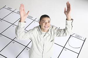 teenage boy standing on a calendar