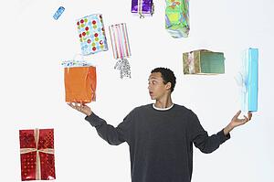 a man juggling holiday gifts