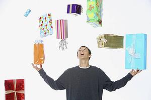 a man juggling holiday gifts