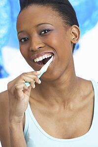 Young Woman Brushing Teeth In Studio