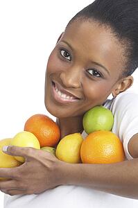Young Woman Holding Citrus Fruit In Studio