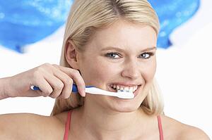 Young Woman Brushing Teeth In Studio