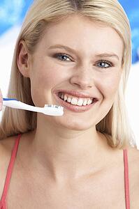 Young Woman Brushing Teeth In Studio
