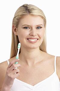 Young Woman Brushing Teeth In Studio