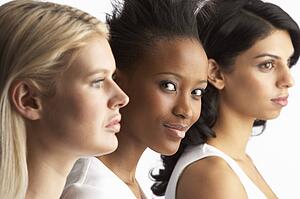 Portrait Of Three Attractive Young Women In Studio Standing In Line