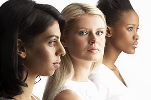 Portrait Of Three Attractive Young Women In Studio Standing In Line