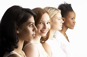 Portrait Of Four Attractive Young Women In Studio Standing In Line