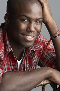 Fashionable Young Resting On Chair Man Wearing Casual Clothes In Studio