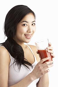 Young Woman Enjoying Healthy Drink In Studio