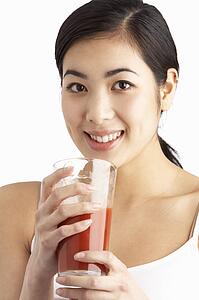 Young Woman Enjoying Healthy Drink In Studio