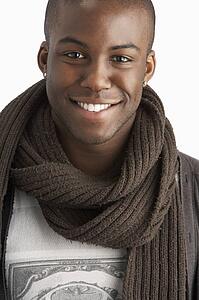 Young Man Wearing Warm Winter Clothing In Studio