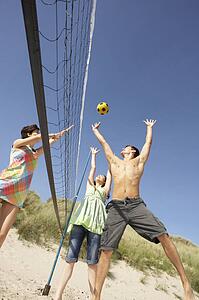 Group Of Teenage Friends Playing Volleyball On Beach