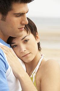 Romantic Young Couple Embracing On Beach 