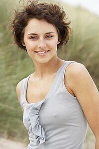 Attractive Young Woman Kneeling Amongst Sand Dunes