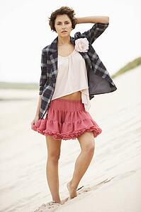 Fashionably Dressed Attractive Young Woman Standing Amongst Sand Dunes