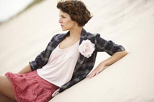 Fashionably Dressed Attractive Young Woman Standing Amongst Sand Dunes