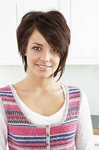 Young Woman Relaxing In Modern Kitchen 