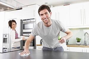 Young Couple Cleaning Cleaning Modern Kitchen 