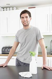 Young Man Cleaning Modern Kitchen 