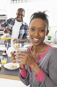 Young Couple Preparing Breakfast In Modern Kitchen