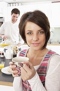 Young Couple Preparing Breakfast In Modern Kitchen 