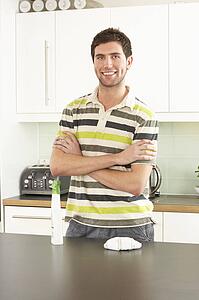 Young Man Cleaning Modern Kitchen 