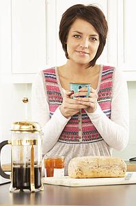Young Woman Preparing Breakfast In Modern Kitchen 