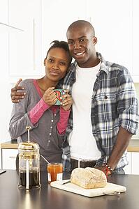Young Couple Preparing Breakfast In Modern Kitchen 