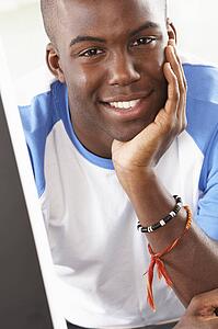Young Man Using Computer In Modern Kitchen 