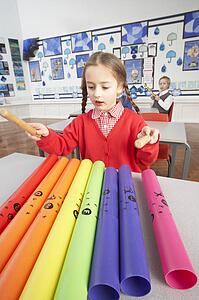 Group Of Primary Schoolchildren Having Music Lesson In Classroom