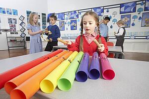 Group Of Primary Schoolchildren Having Music Lesson In Classroom