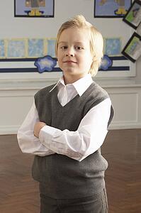 Portrait Of Male Primary School Pupil Standing In Classroom