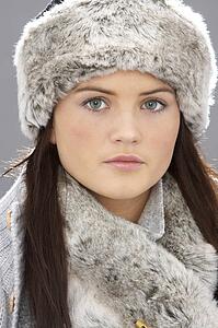 Studio Portrait Of Young Woman Wearing Fur Hat And Wrap