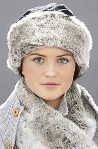 Studio Portrait Of Young Woman Wearing Fur Hat And Wrap