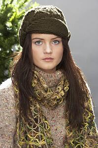 Fashionable Teenage Girl Wearing Cap And Knitwear In Studio In Front Of Christmas Tree