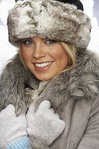 Studio Portrait Of Young Woman Wearing Fur Hat And Coat