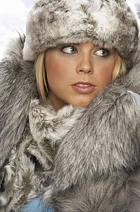 Studio Portrait Of Young Woman Wearing Fur Hat And Coat