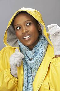 Young Woman Wearing Yellow Raincoat In Studio