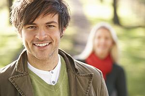 Portrait Of Romantic Young Couple In Autumn Park