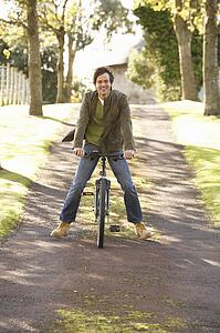 Portrait Of Young Man With Cycle In Autumn Park