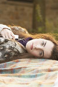 Portrait Of Beautiful Teenage Girl Outdoors Listening To MP3 Player In Autumn Landscape